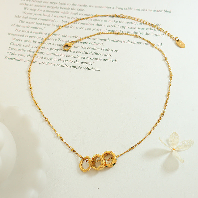 Delicate gold necklace with interconnected circular charms, meaningful jewelry for anxiety