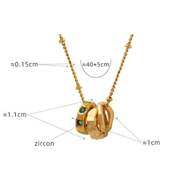 Gold necklace with three linked rings featuring green zircon stones meaningful jewelry for anxiety