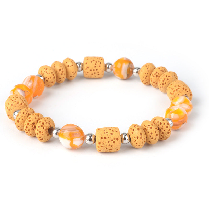 Mens healing lava rock bracelet with natural porous beads and orange marbled accents