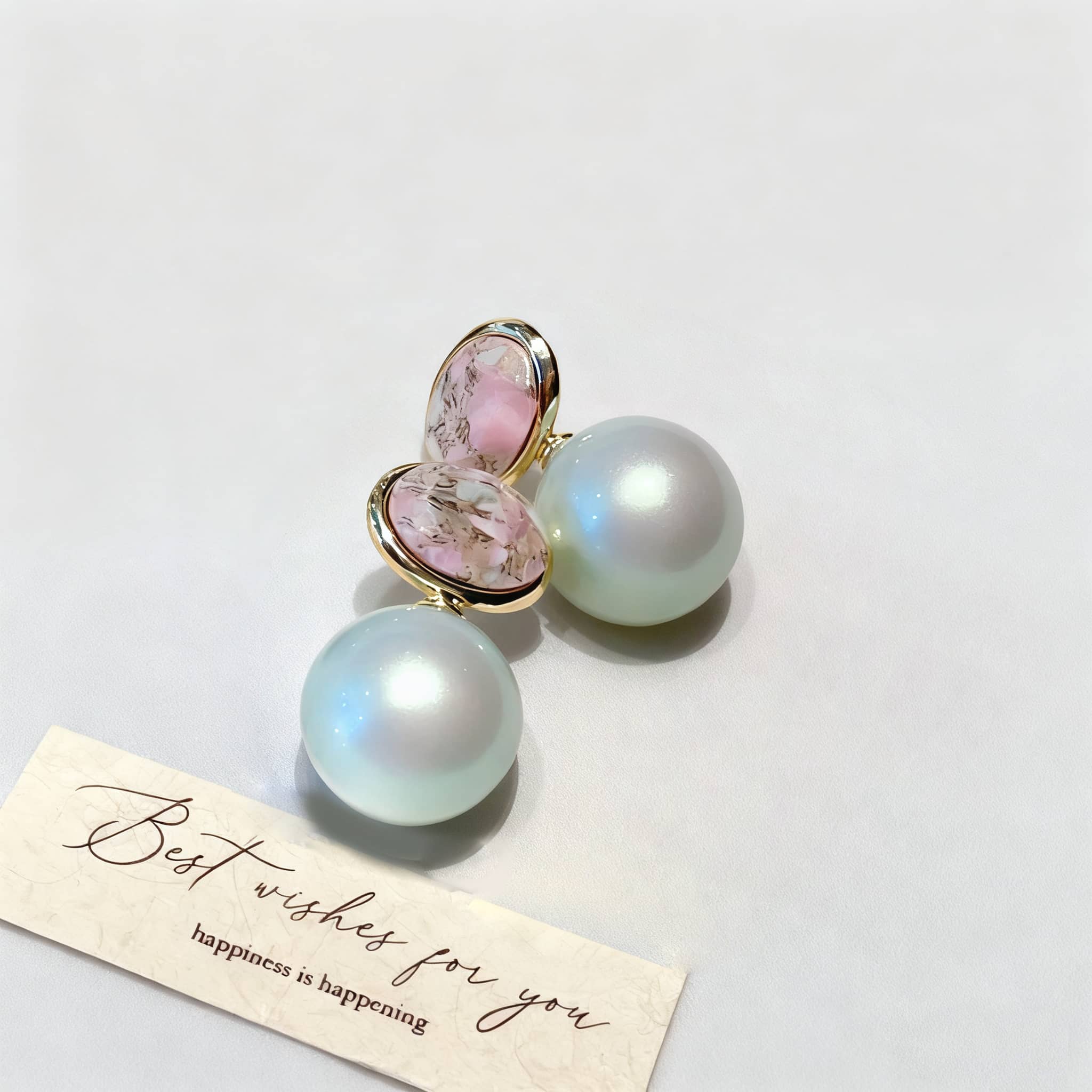 Mint pearl ceramic earrings featuring a glossy finish and elegant design with a pink accent
