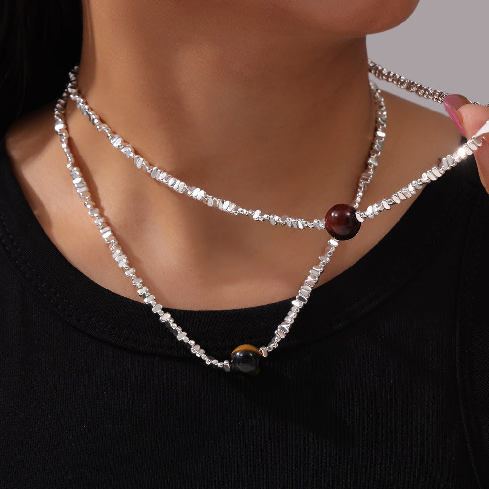 Anxious healing crystal necklace silver chain with dark round beads worn on model neck