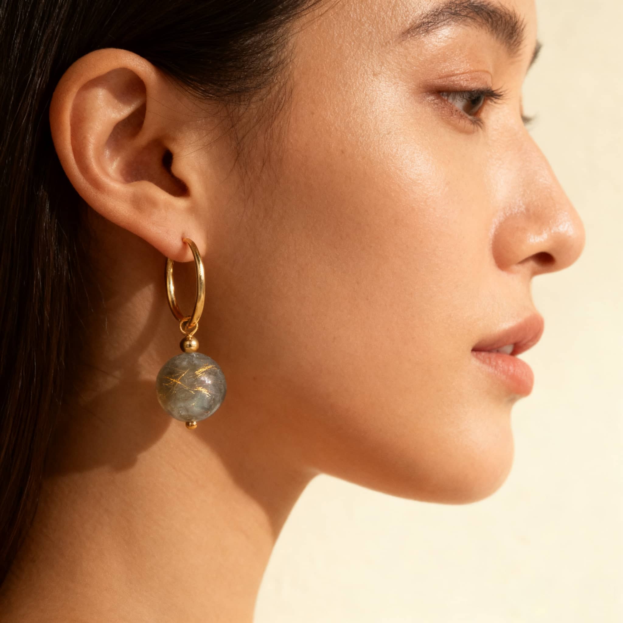 Elegant moonstone anxiety earrings from 5 Senses, featuring gold accents and a beautiful gemstone