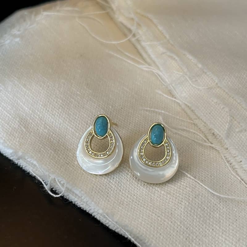 Elegant mother-of-pearl and blue turquoise earrings with gold accents for a sophisticated look