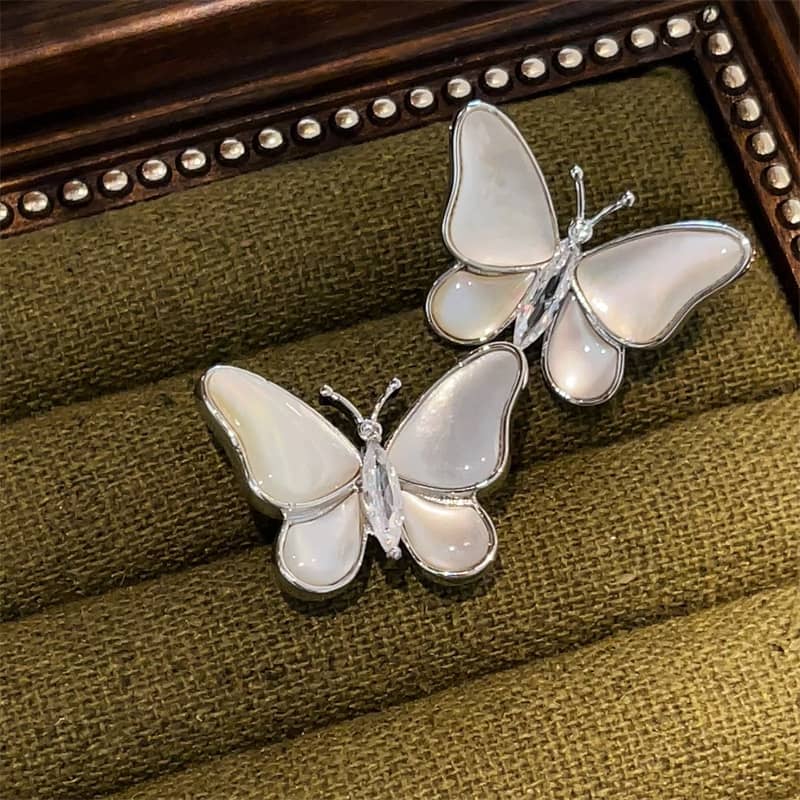 Elegant mother of pearl butterfly earrings with a shiny silver outline, perfect for any occasion