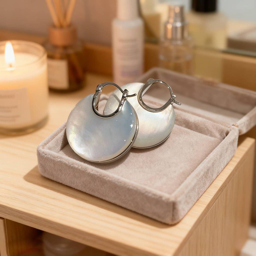 Elegant mother of pearl ear cuffs displayed in a soft velvet box for stylish accessory lovers