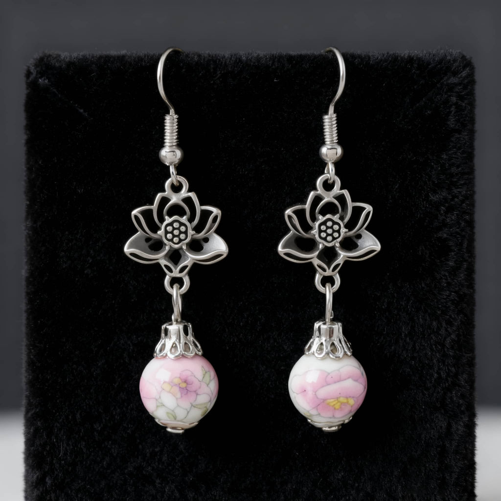 Elegant pink ceramic lotus earrings with silver flower accents for a stylish look
