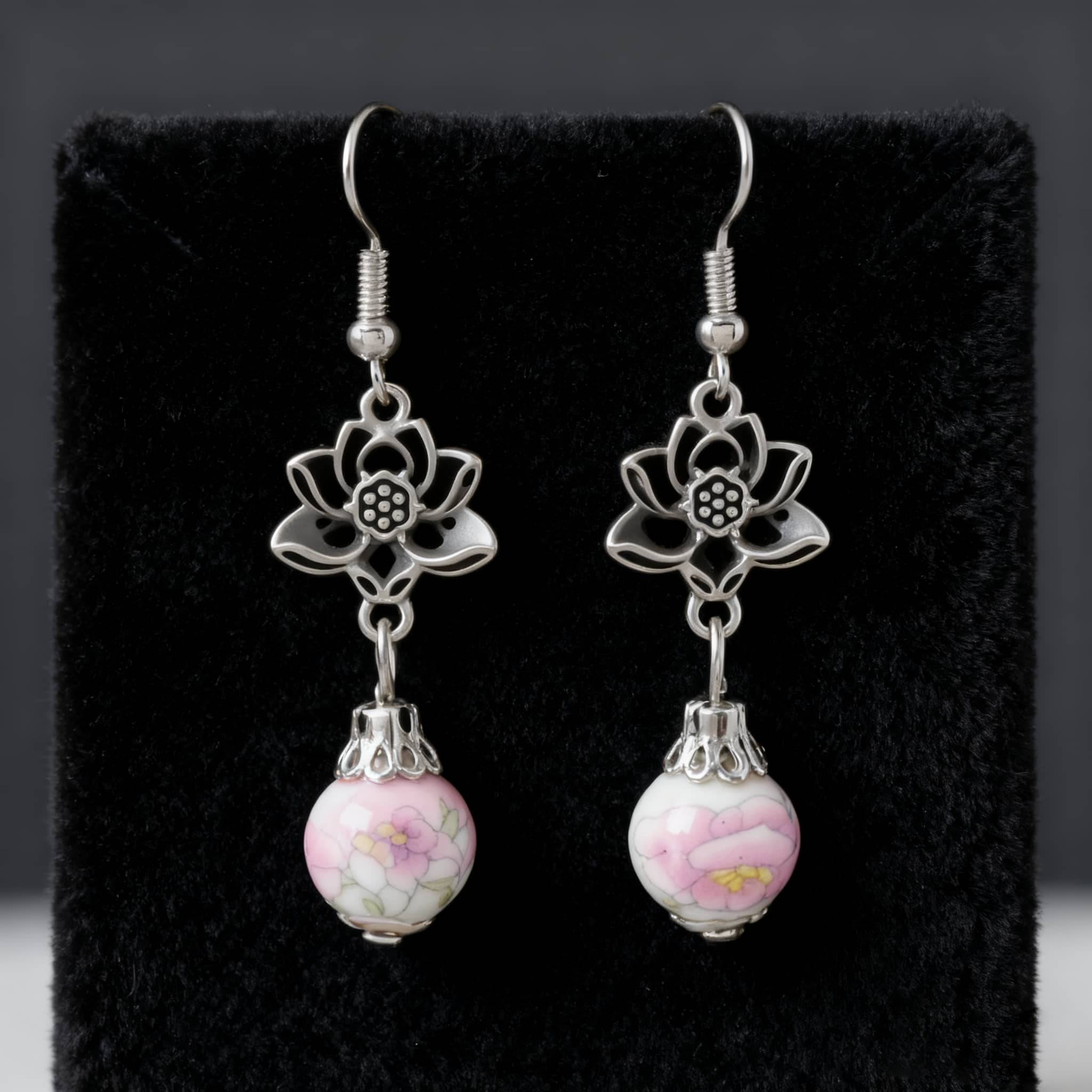 Elegant pink ceramic lotus earrings with silver flower accents for a stylish look