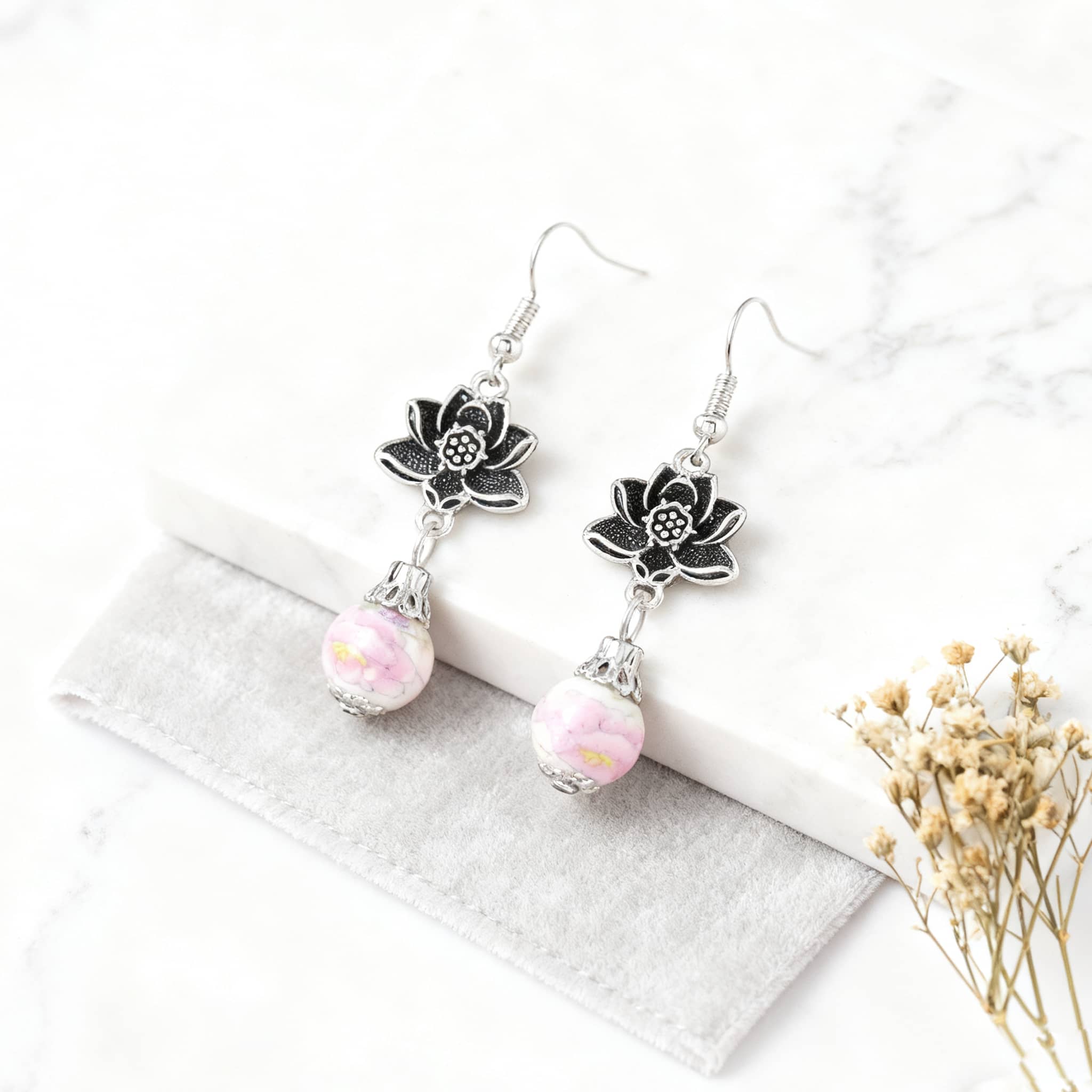 Stylish pink ceramic lotus earrings with silver floral accents for a trendy look