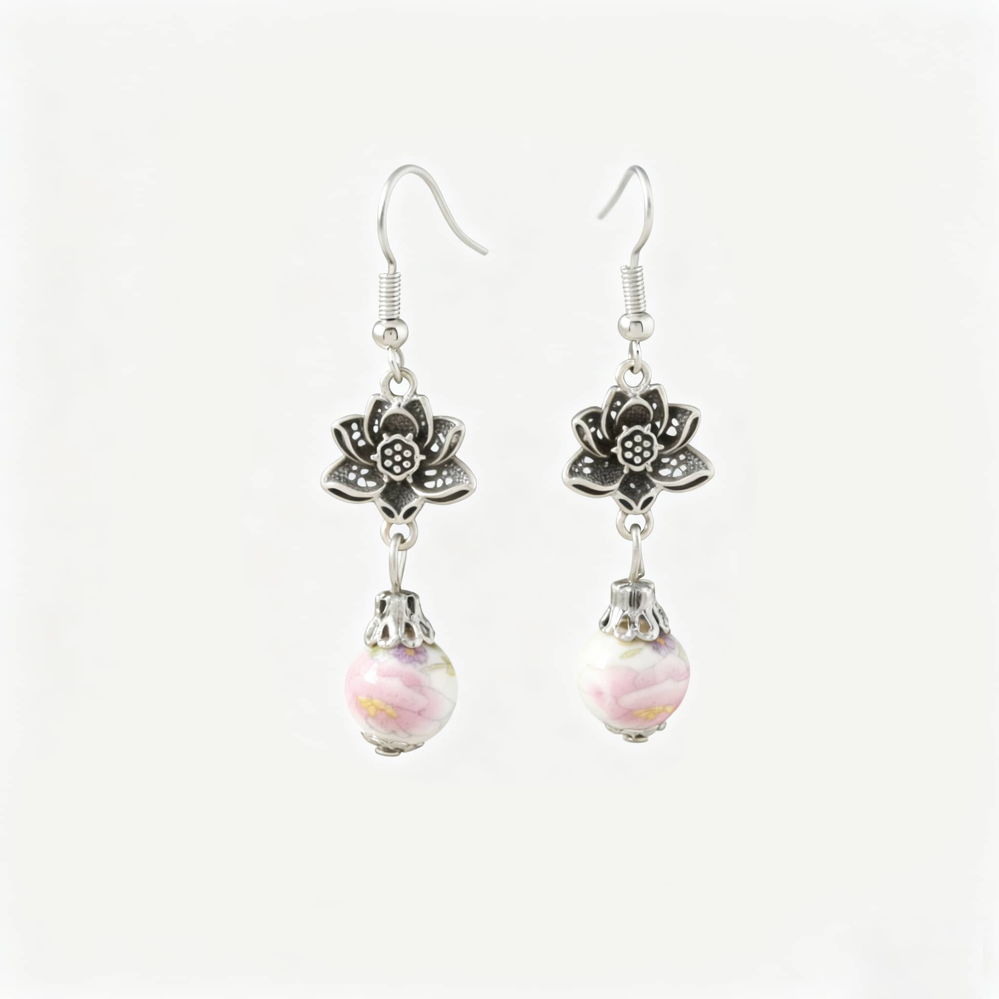 Pink ceramic lotus earrings featuring floral design and elegant drop accent