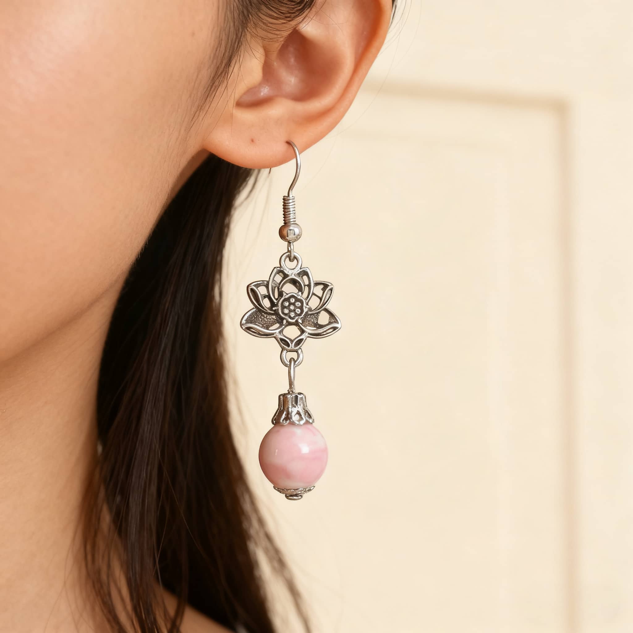 Pink ceramic lotus earrings with a floral design and dangling bead for a stylish look