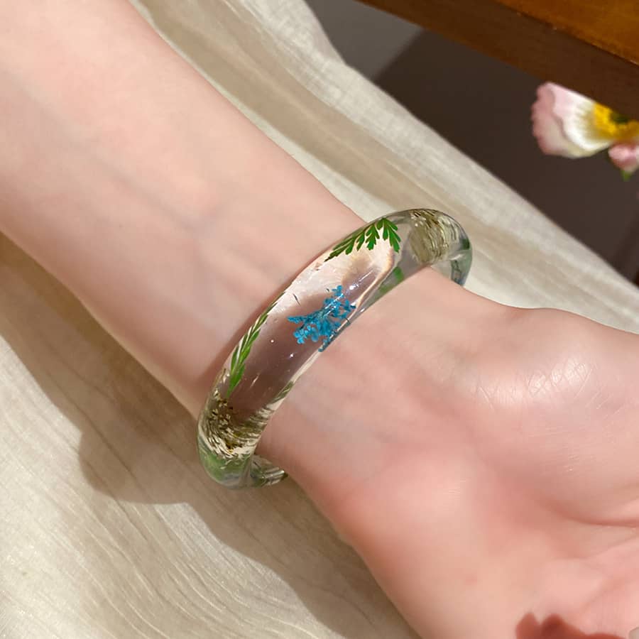 Joy Bracelet featuring preserved flower resin bracelet with vibrant green and blue floral design