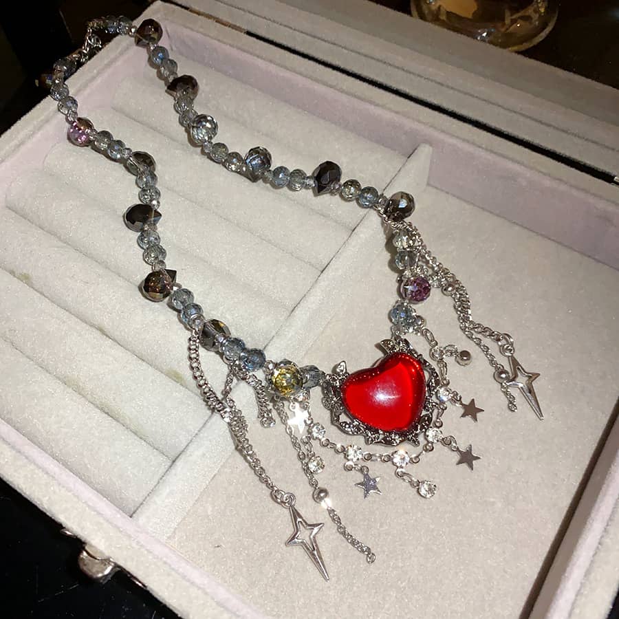 Punk heart fringe necklace featuring a bold red heart and silver star charms for a unique style