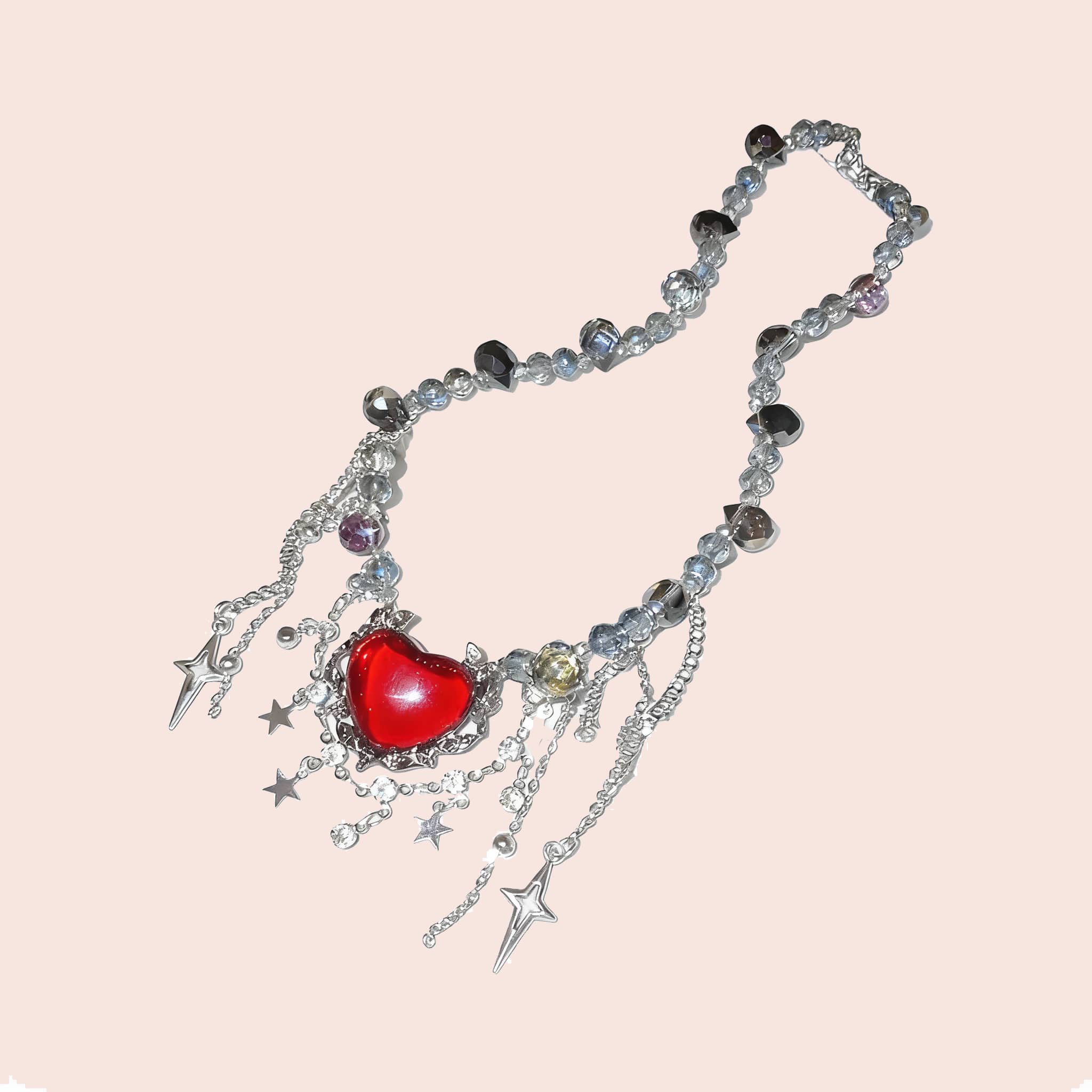 Punk heart fringe necklace featuring a red heart pendant with silver chains and star charms