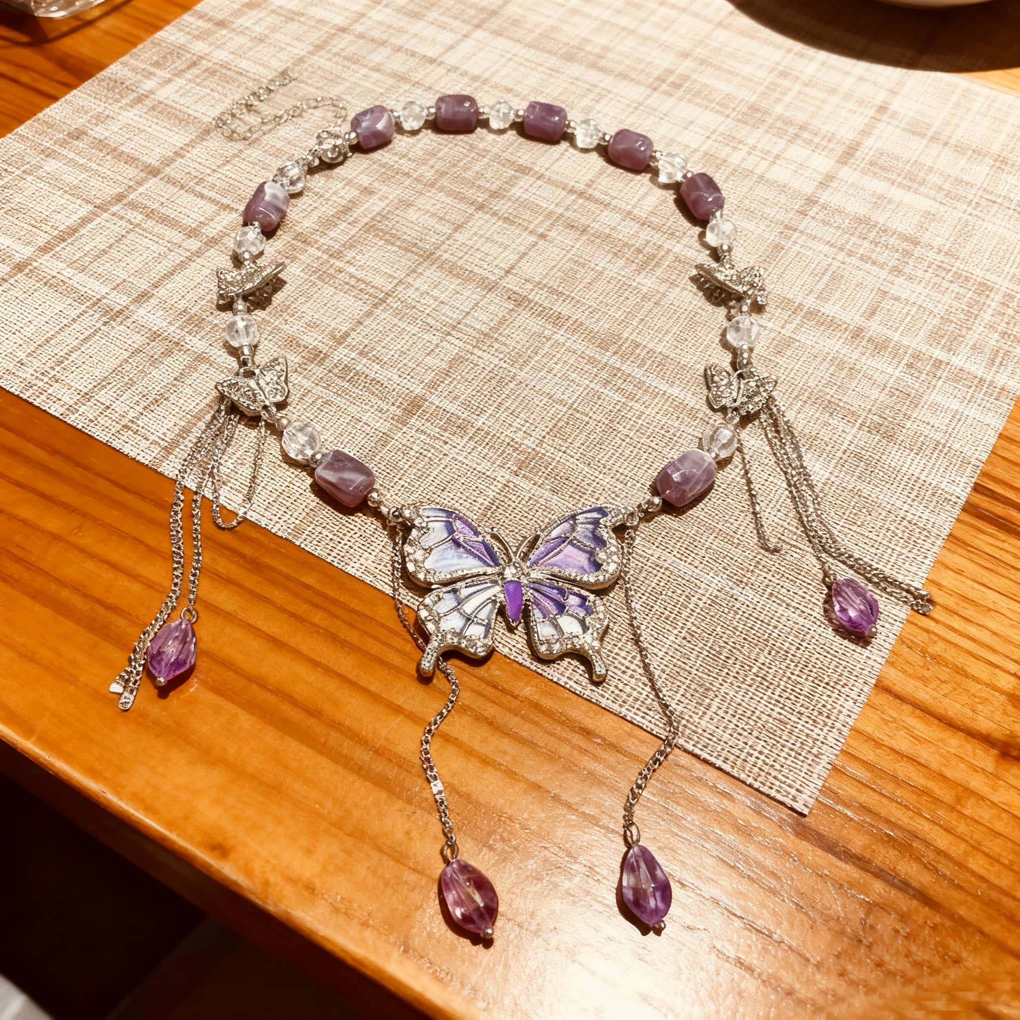 Elegant purple butterfly necklace adorned with amethyst beads and butterfly charms for a unique look