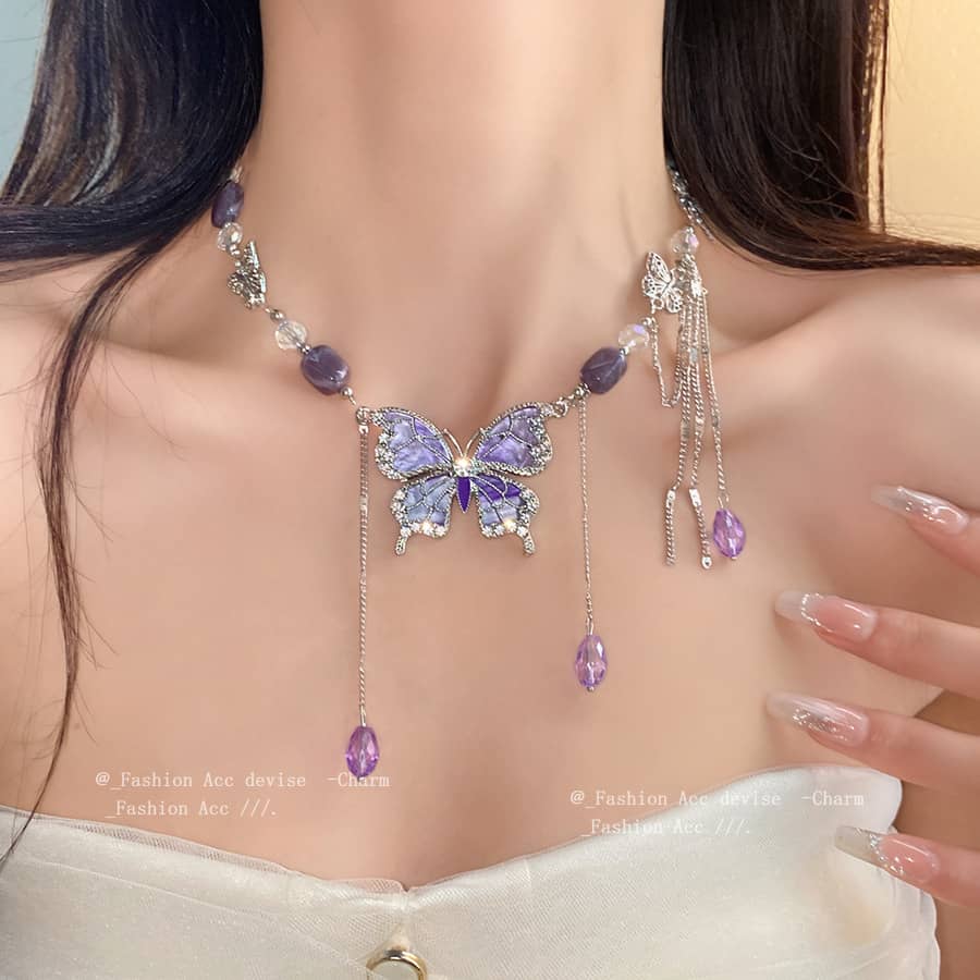 Purple butterfly necklace from 5 Senses featuring intricate designs and sparkling embellishments