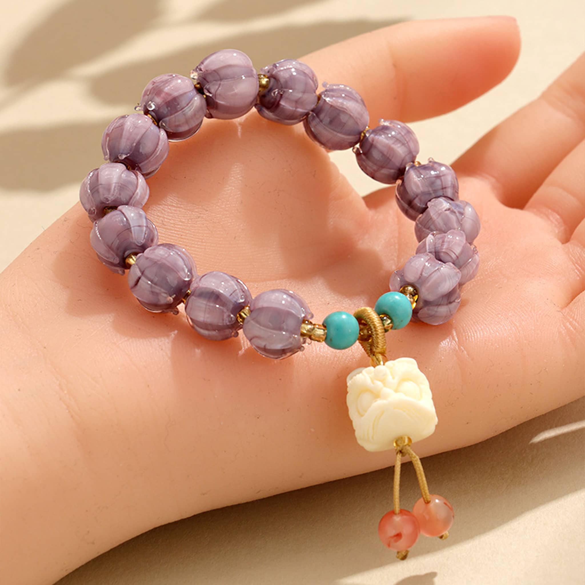 Purple gemstone self-care bracelet with decorative beads and charm for anxiety relief