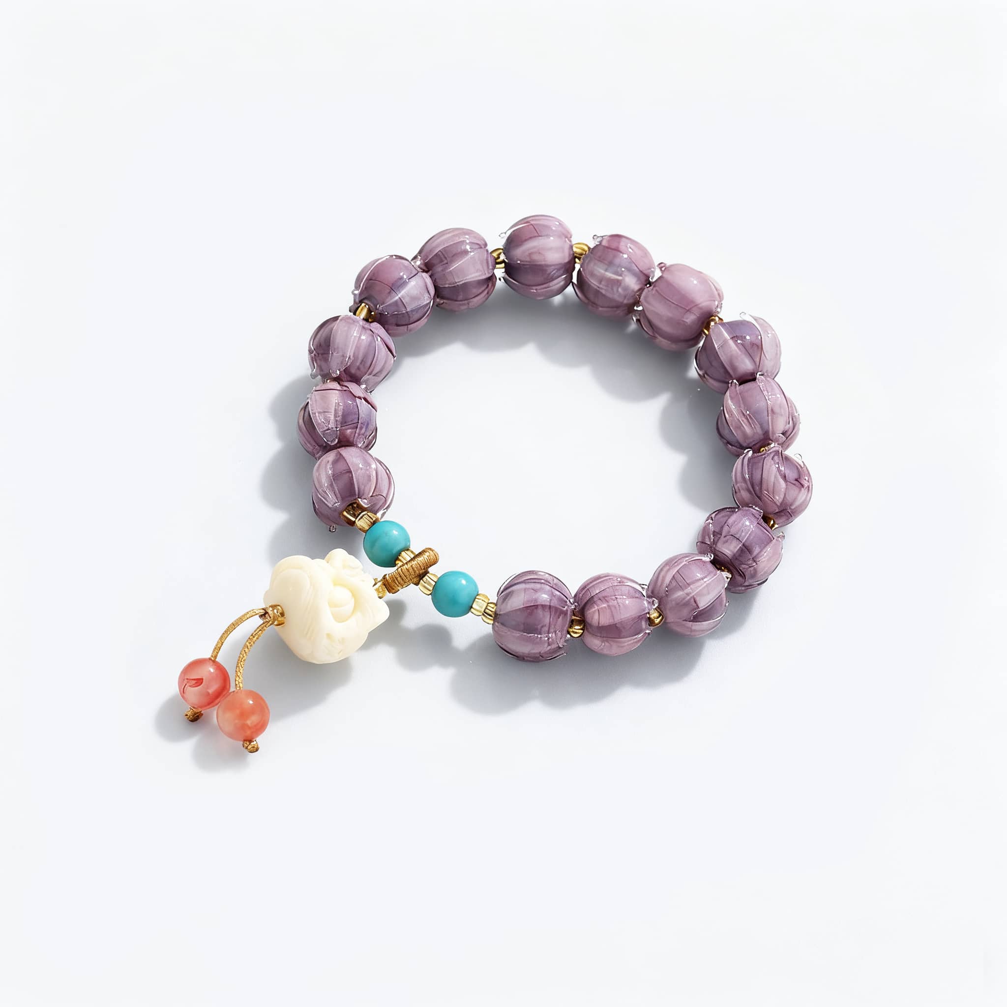Purple gemstone self-care bracelet featuring ornate beads and a decorative charm for calming energy