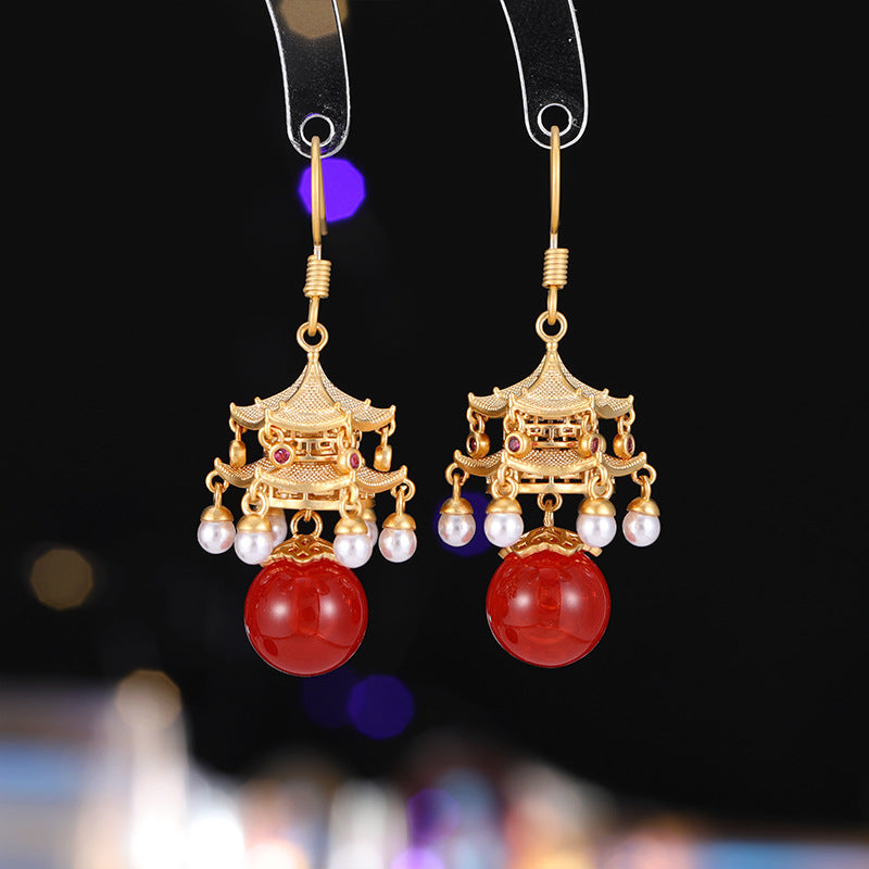 Calm red agate pearl earrings with gold pagoda design and dangling pearls