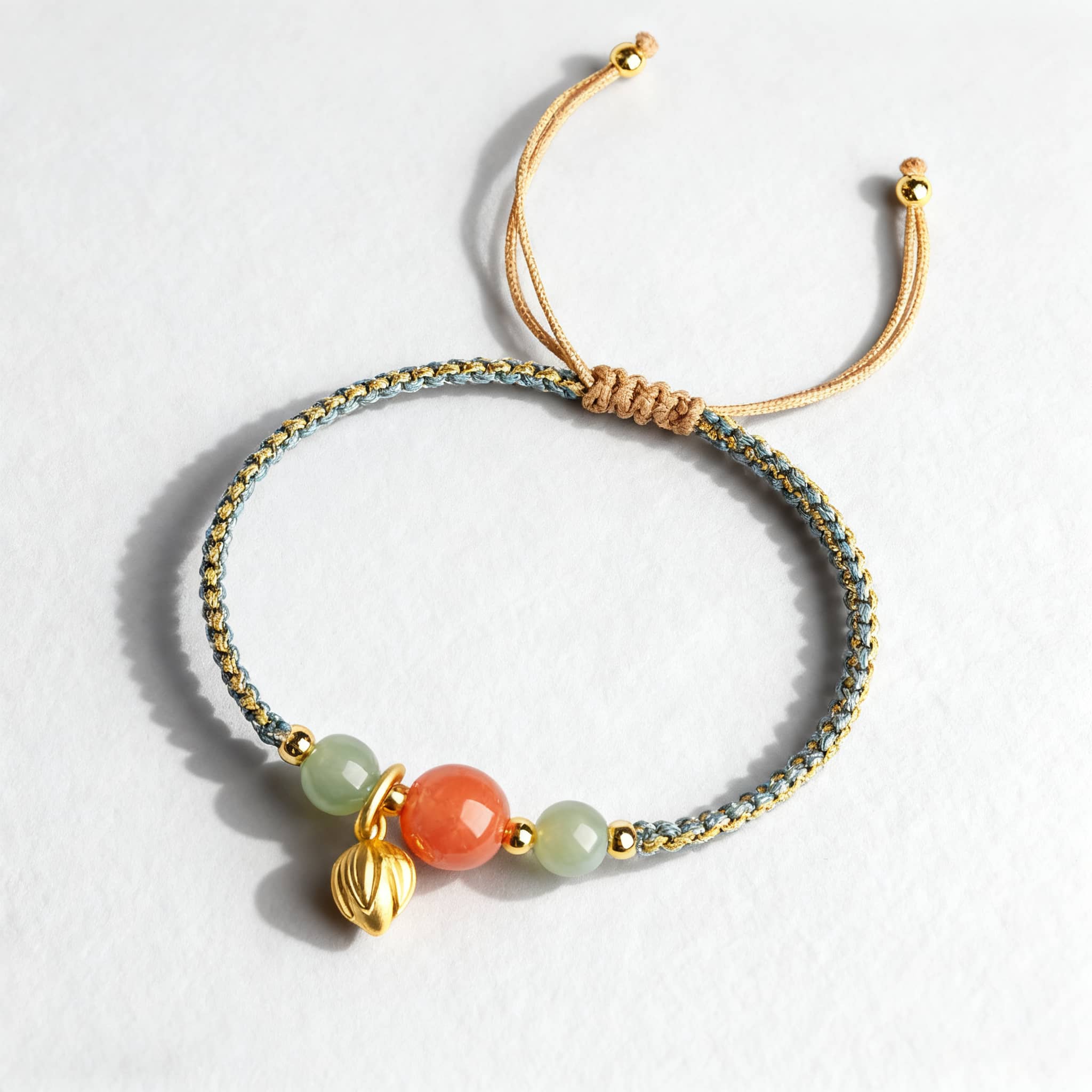 Red chalcedony lotus bracelet with gold accents and adjustable cord for a stylish accessory