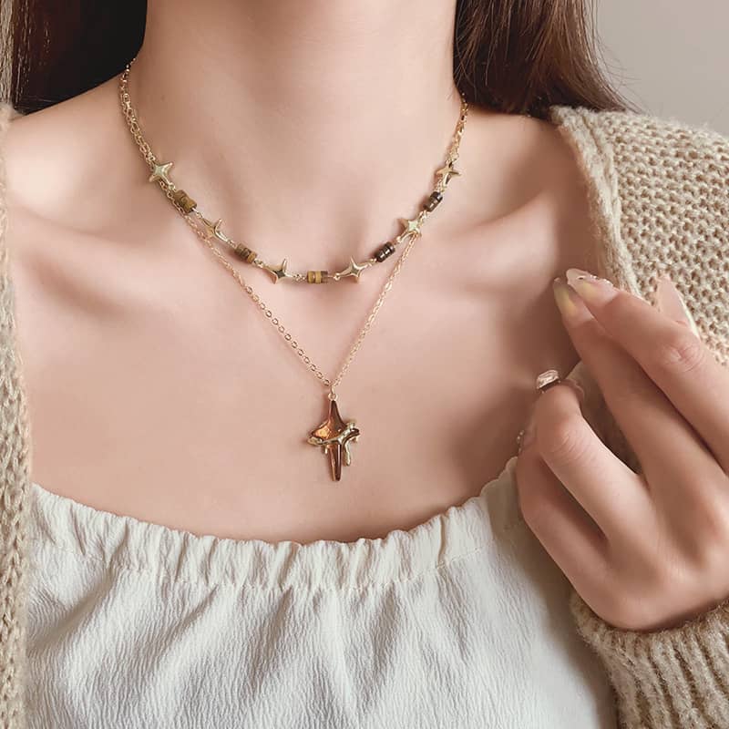 Angry necklace featuring a resin star pendant jewelry and elegant gold chain design