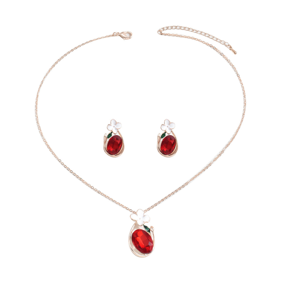 Red oval gemstone pendant with white flower and green leaf accents in a red diamond necklace and earrings set on gold chain