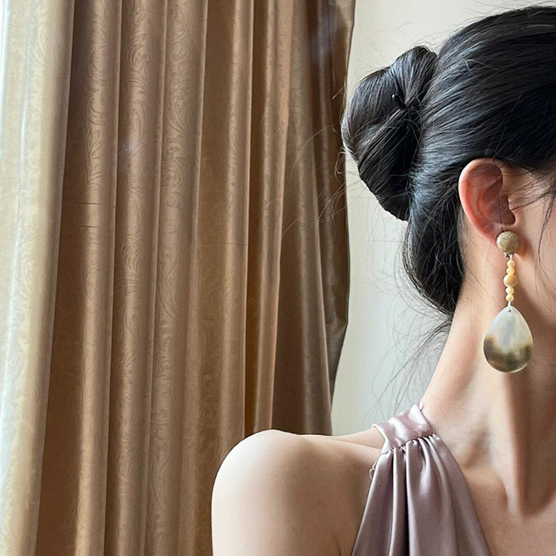 Elegant shell drop earrings for self care, perfect for adding a touch of calm to any outfit