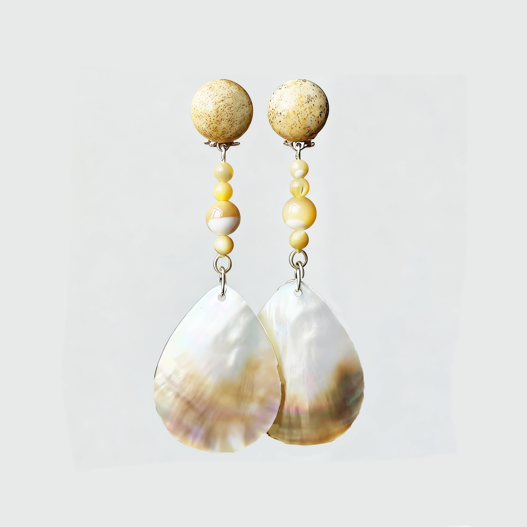 Elegant shell drop earrings for self care featuring yellow beads and natural textures