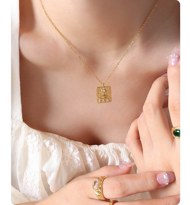 Gold solar guardian pendant necklace worn with white ruffled top and matching gold rings