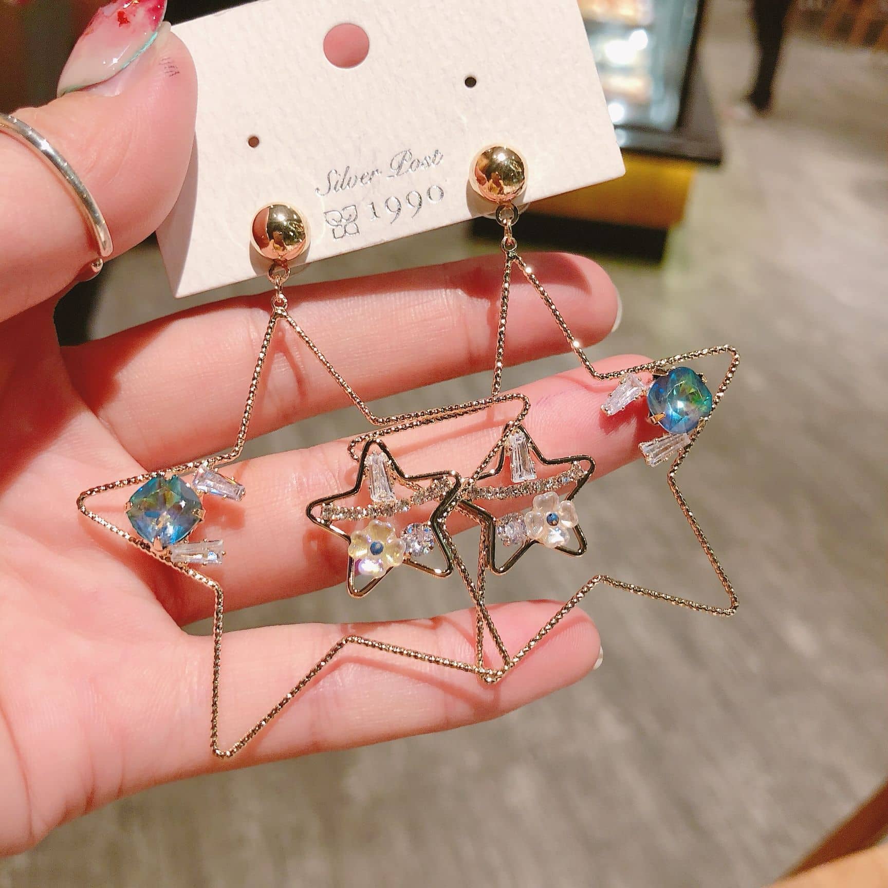 5 Senses starburst stud earrings featuring crystal stars and colorful accents for a trendy look