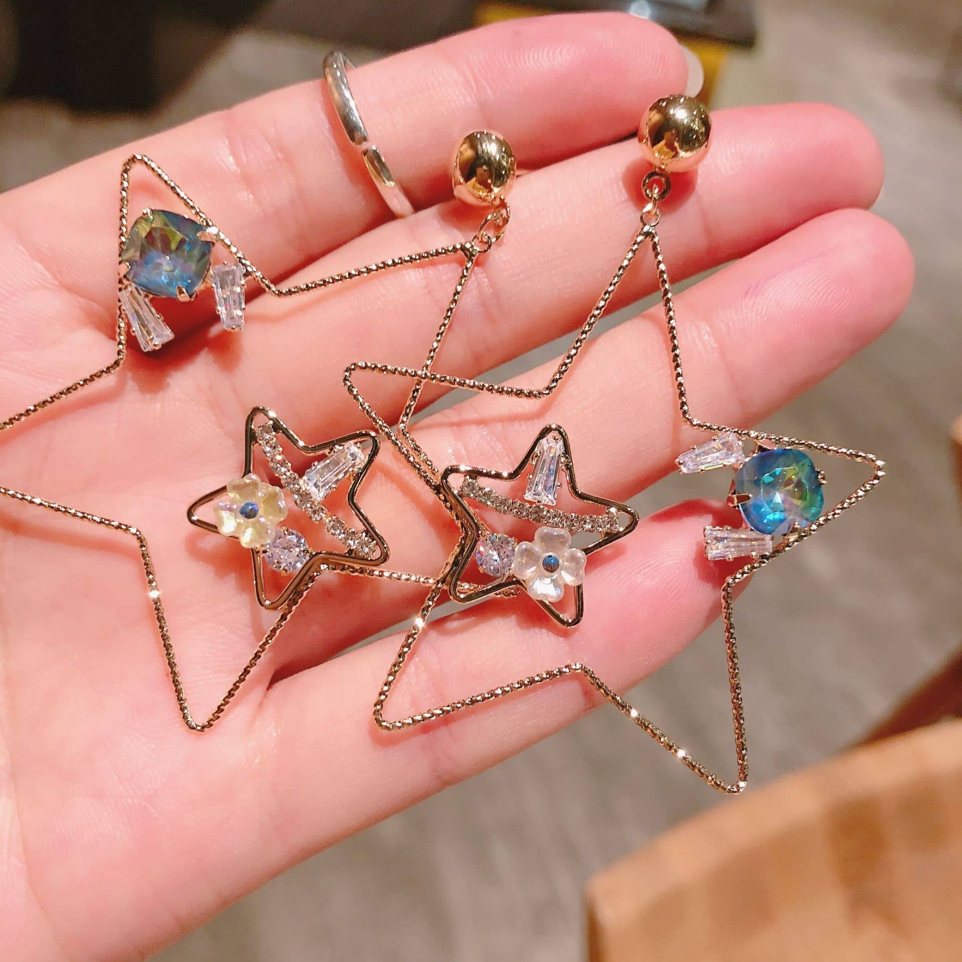 5 Senses starburst stud earrings featuring colorful gemstones and gold star design