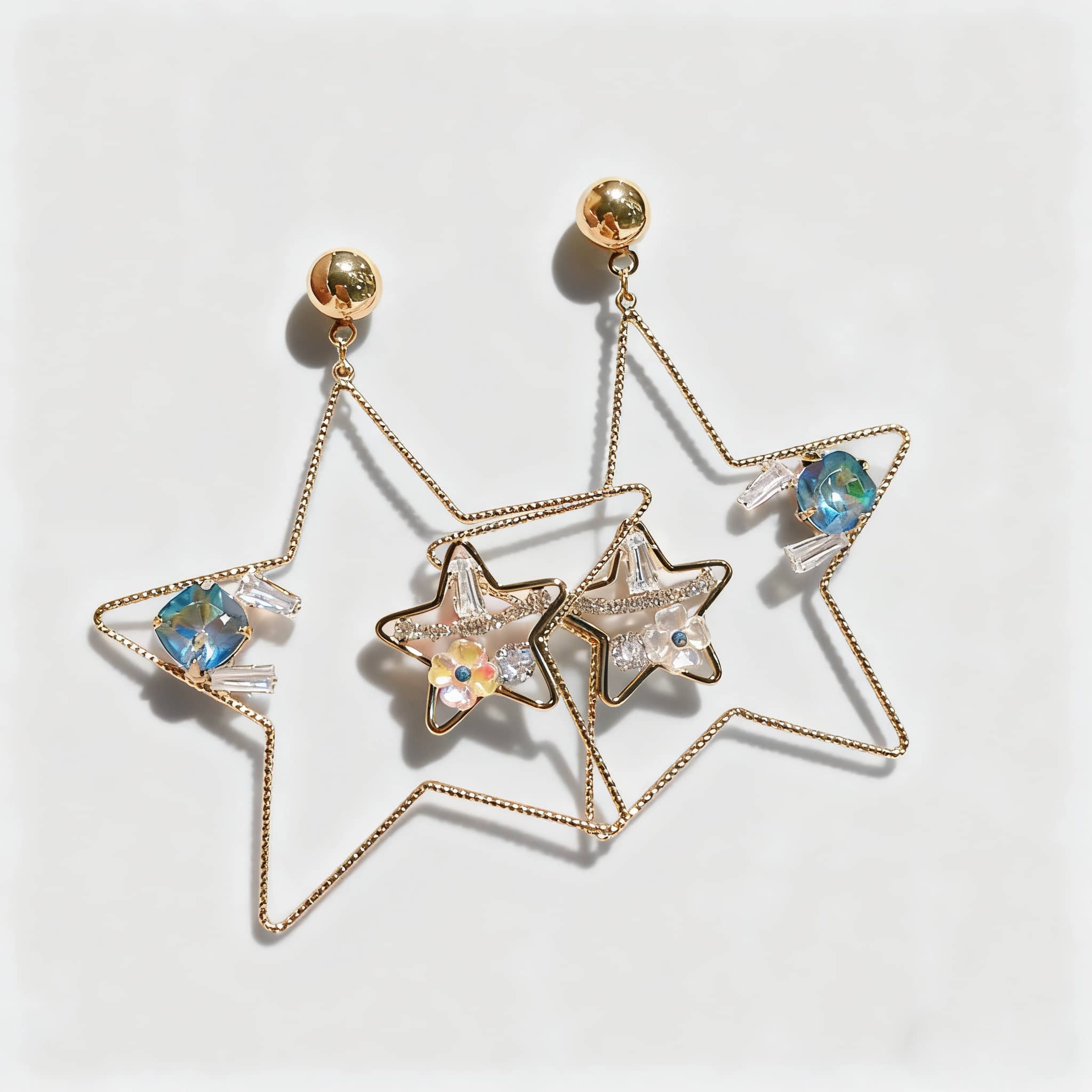 Elegant starburst stud earrings with shimmering crystals in a gold design