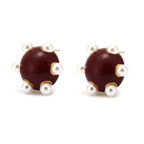 Angry statement gold stud earrings featuring dark brown round studs with white pearl accents