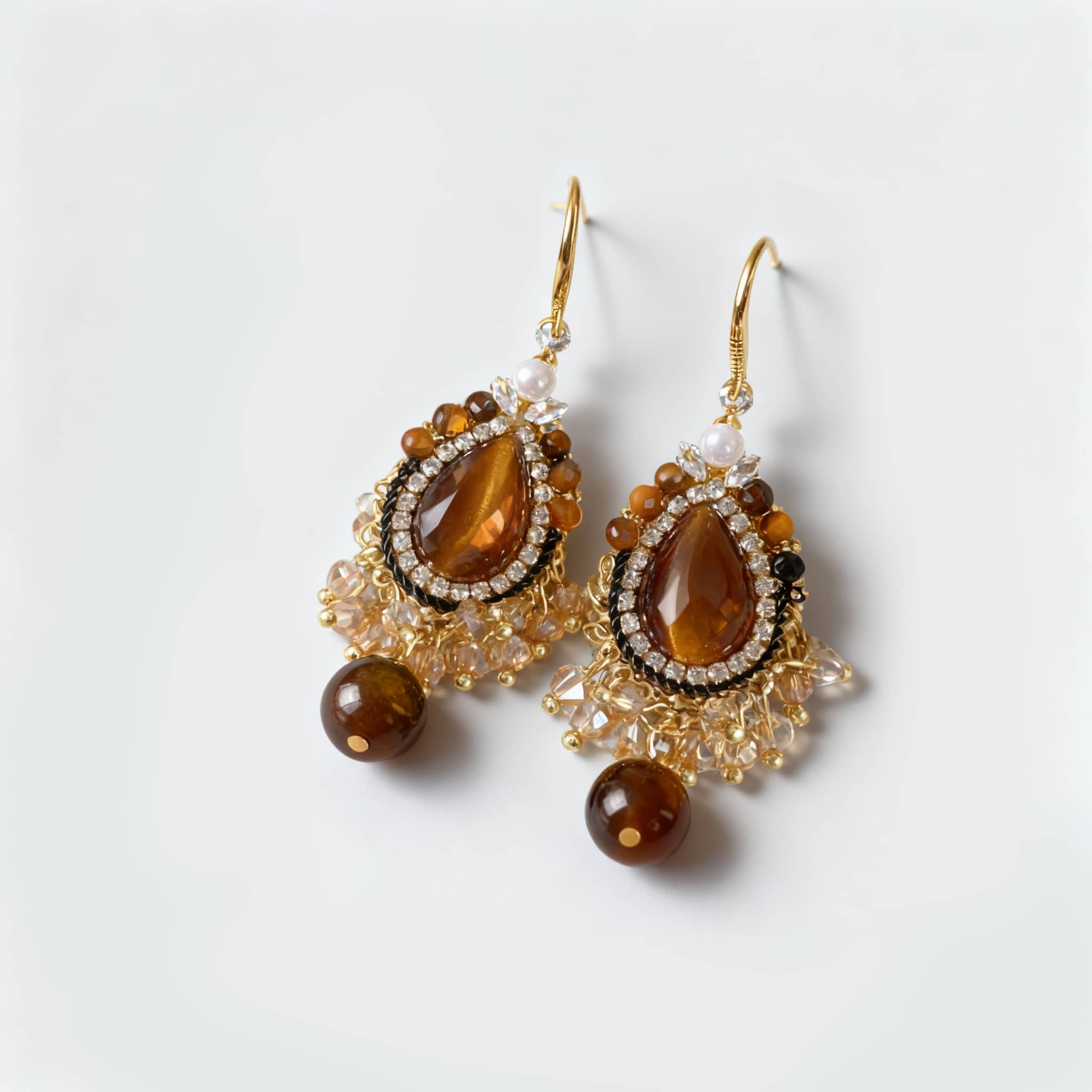 Elegant tiger's eye anxiety relief earrings with intricate beadwork and gold accents