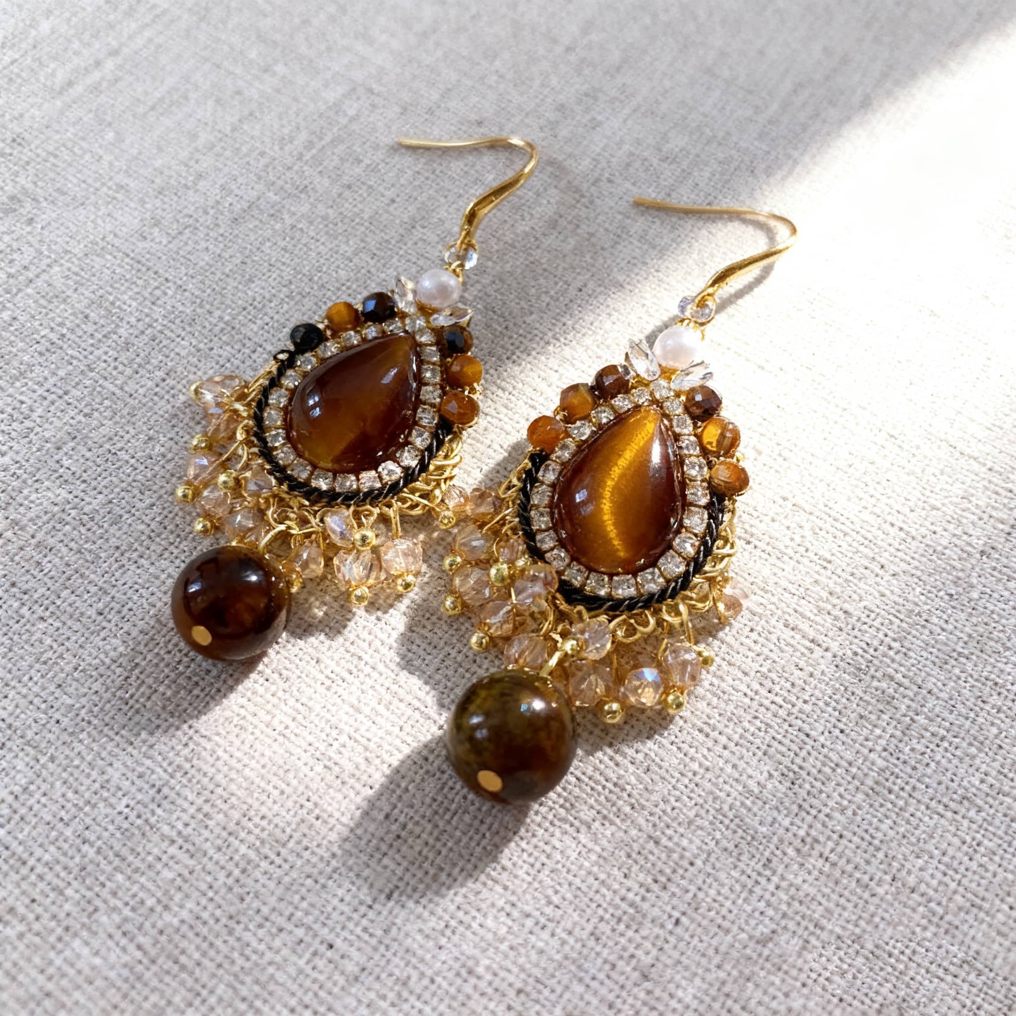 Elegant tiger's eye anxiety relief earrings with a teardrop design and sparkling accents for calming energy