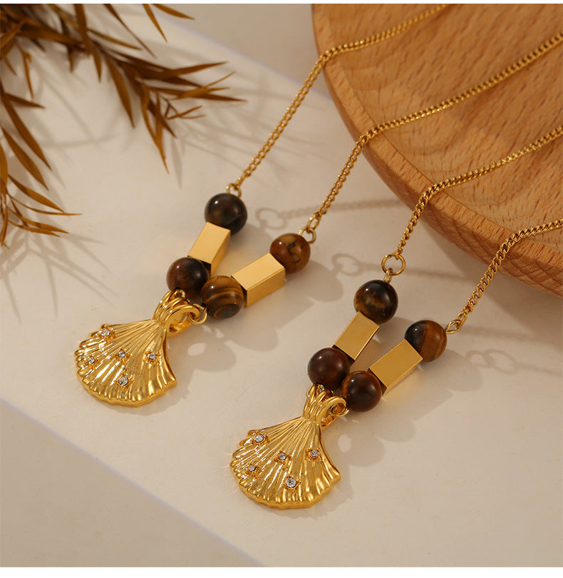 Gold shell pendant necklace with tiger's eye beads designed as tiger's eye jewelry for confidence