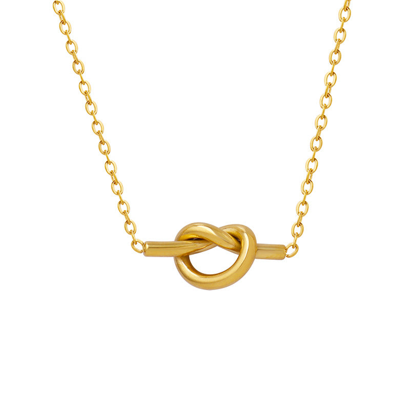 Gold necklace with unique heart knot pendant jewelry featuring a smooth, elegant design