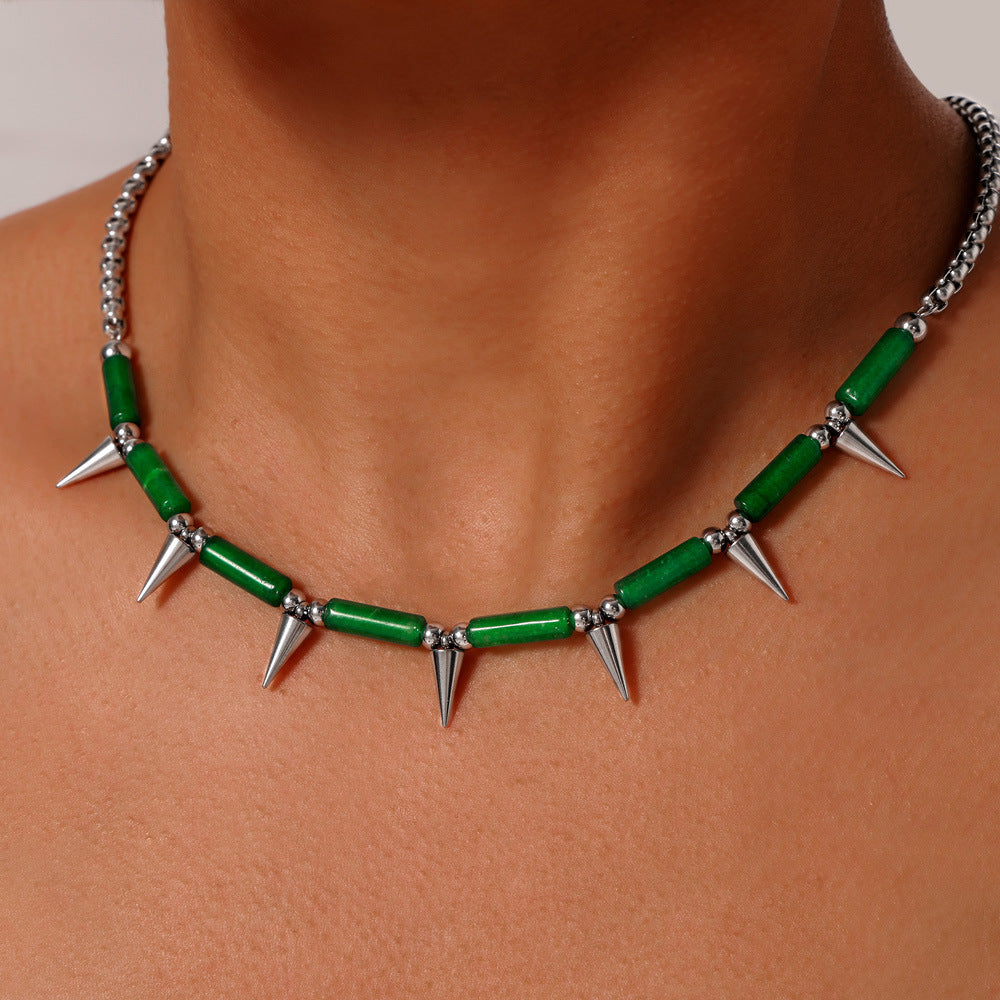Anxious necklace featuring green beads and steel point necklace spikes on a silver chain