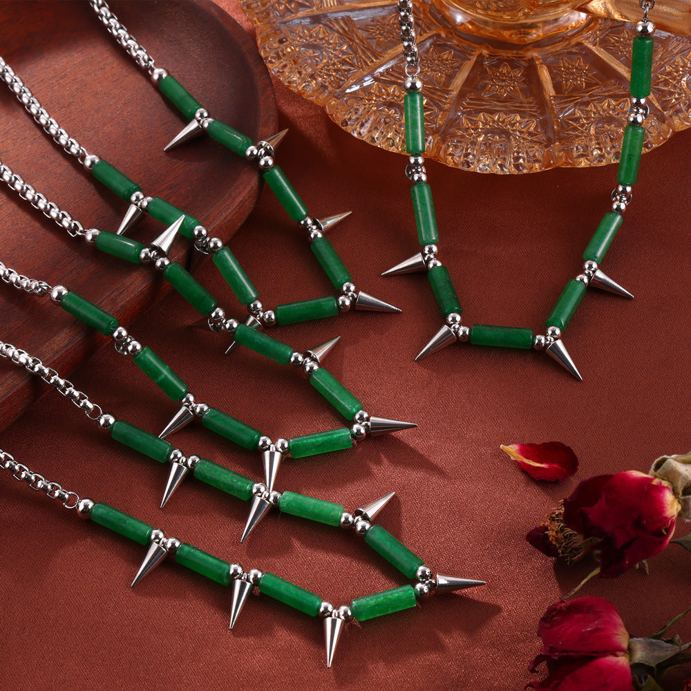 Anxious steel point necklace featuring green beads and sharp silver spikes on a silver chain