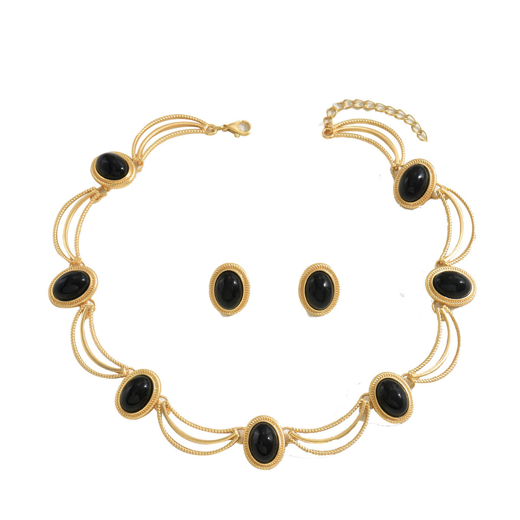 Elegant black gemstone necklace set with gold chain and matching earrings for stylish wear