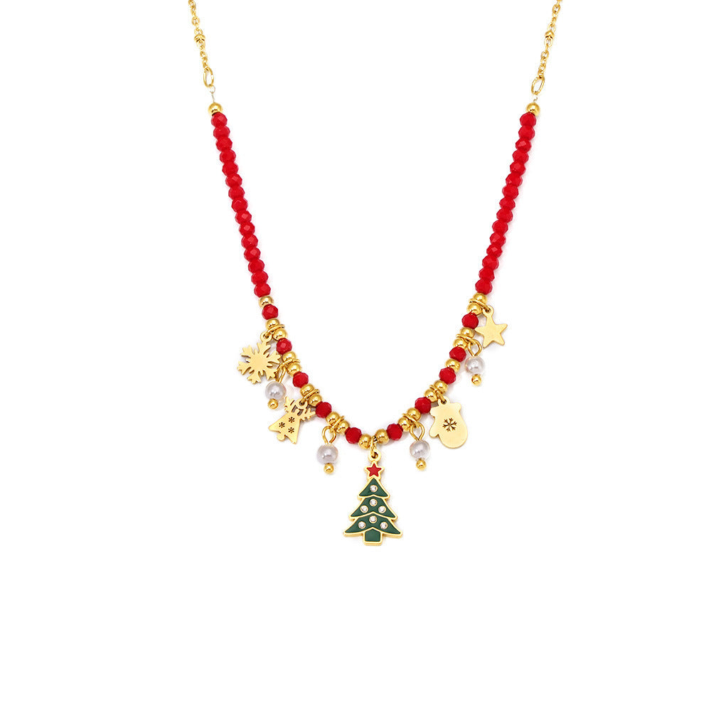 Joy necklace featuring a gold Christmas tree necklace pendant with red beads and festive charms
