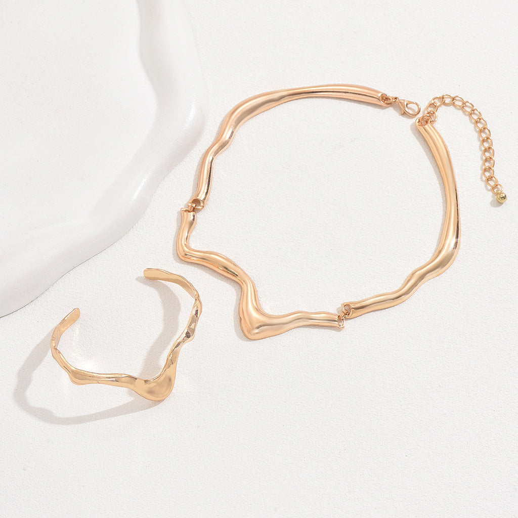 Angry necklace and ring in gold tone resembling molten metal jewelry set with fluid, wavy design