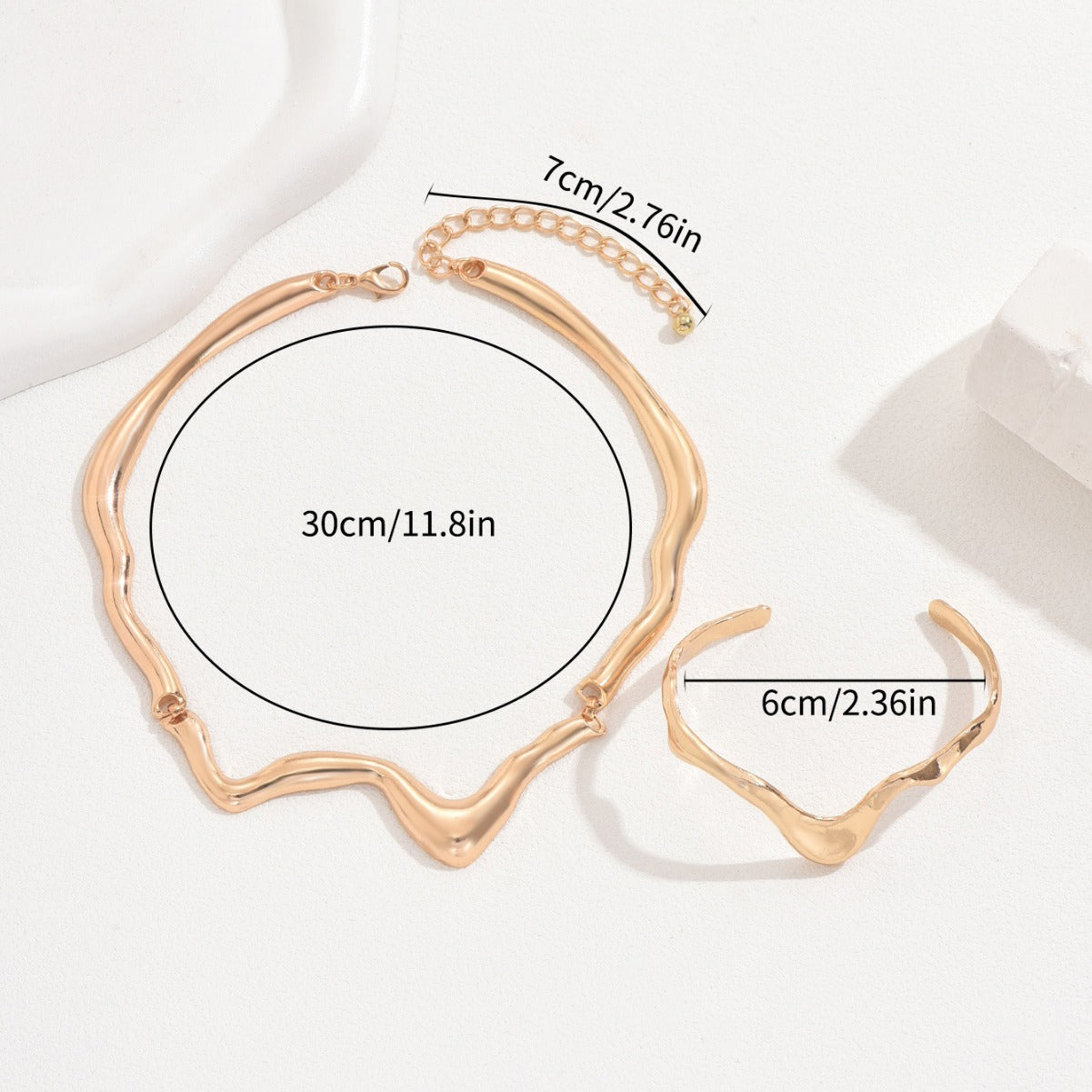 Molten metal jewelry set with wavy gold-tone necklace and matching adjustable bracelet
