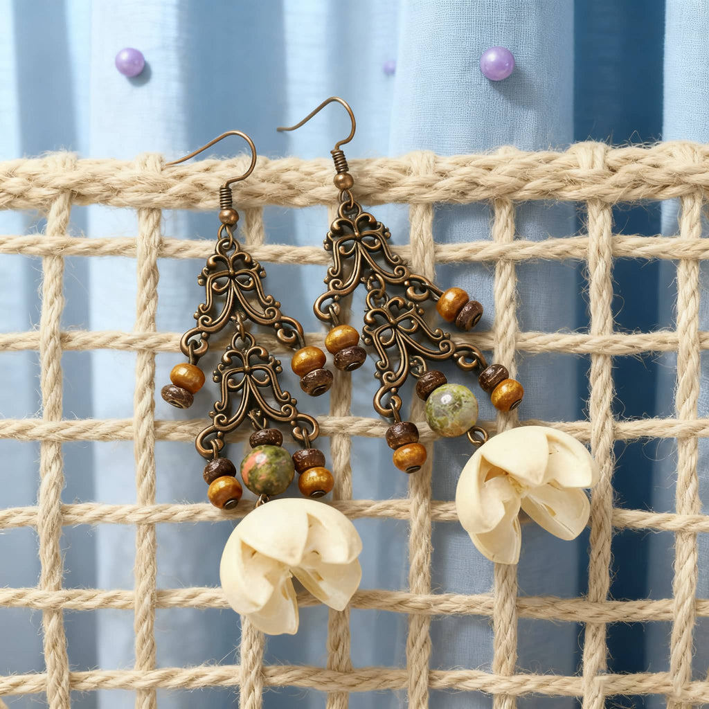 Vintage cut-out metal earrings with decorative beads and floral design for a unique statement look