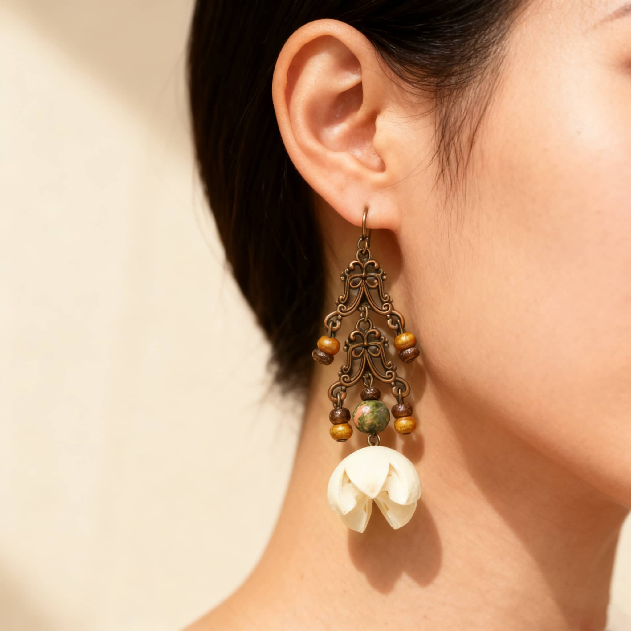 Vintage cut-out metal earrings with decorative charms and beads for a stylish vintage look