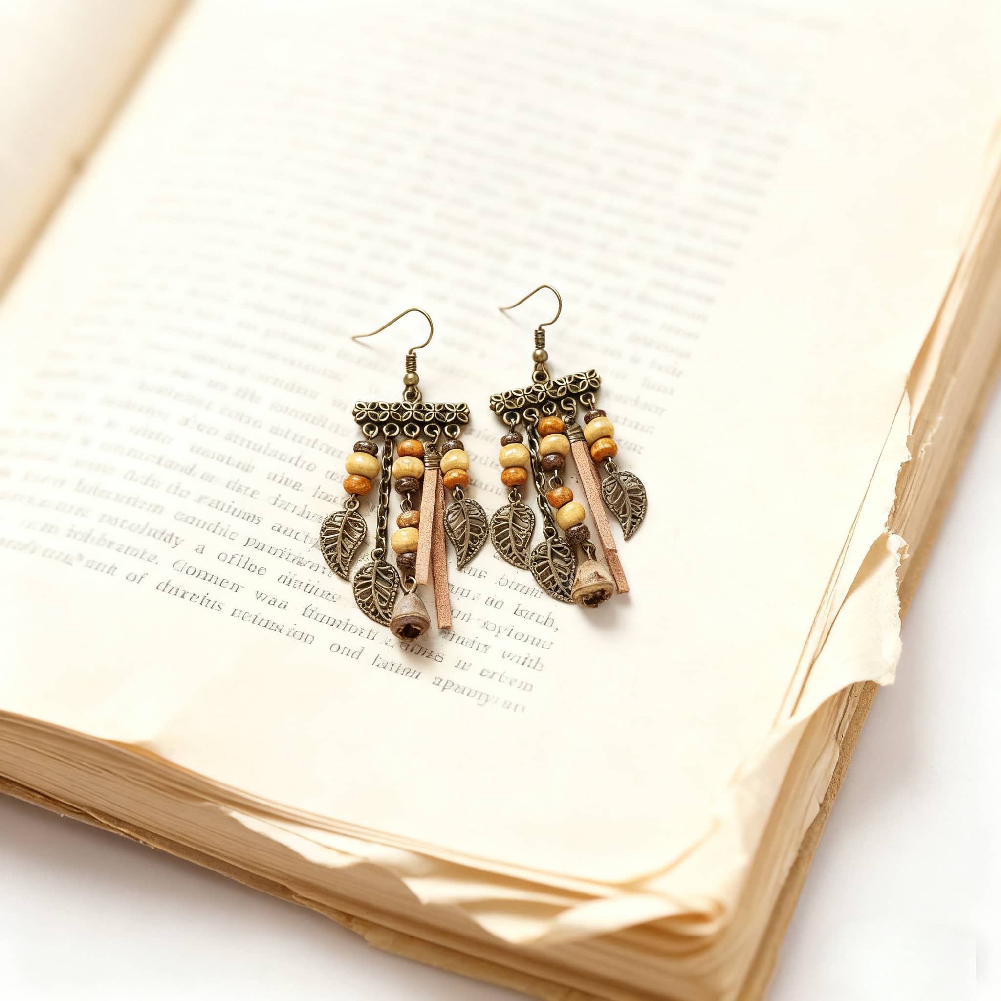 Vintage leaf tassel earrings with decorative beads hanging from an intricate metal design