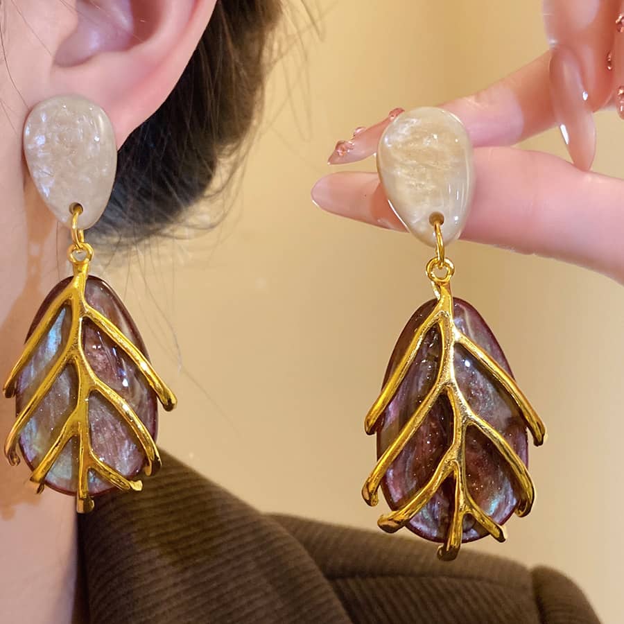 Angry vintage metal cage statement earrings with unique leaf design and elegant gemstone accent