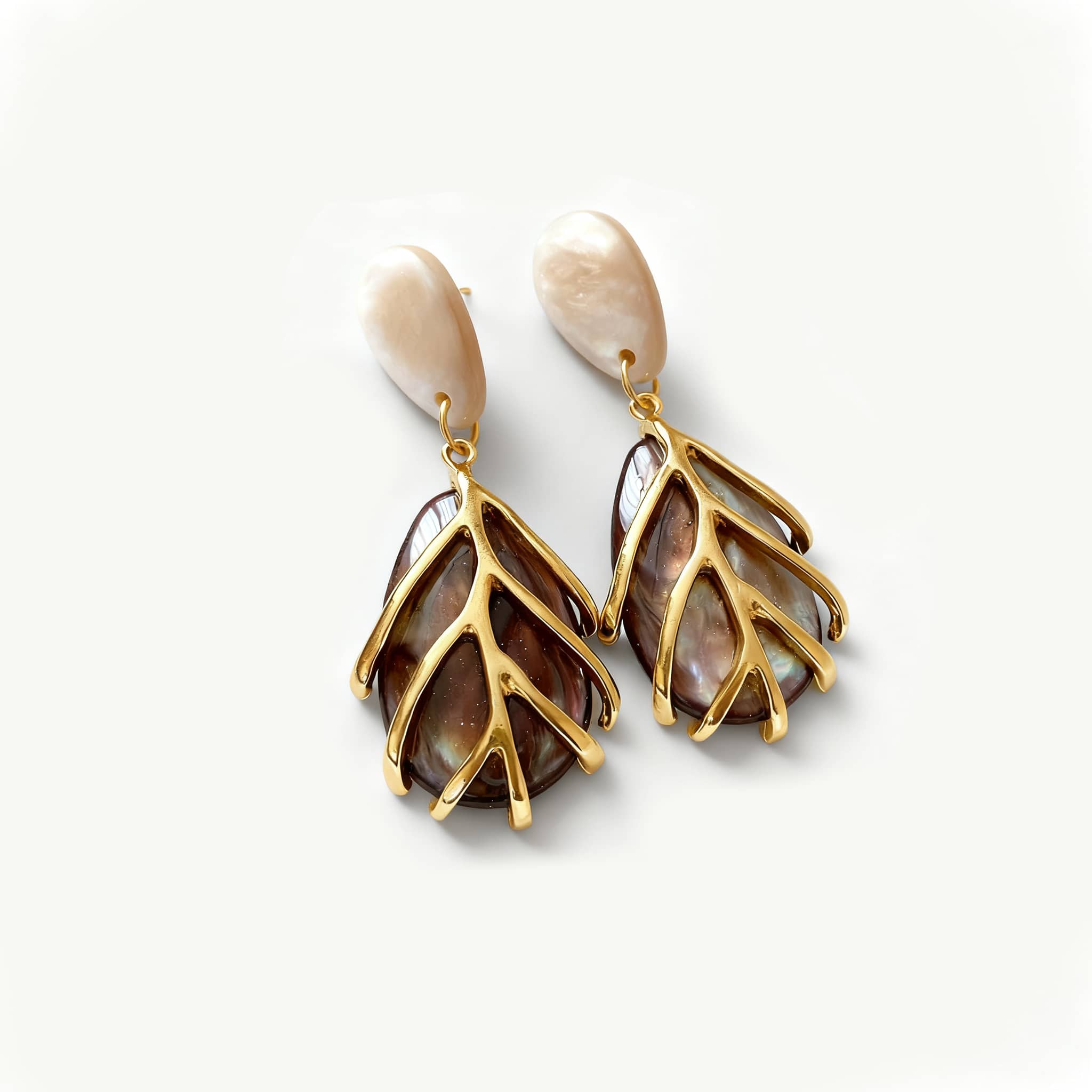 Vintage metal cage statement earrings featuring intricate leaf design with natural abalone accents