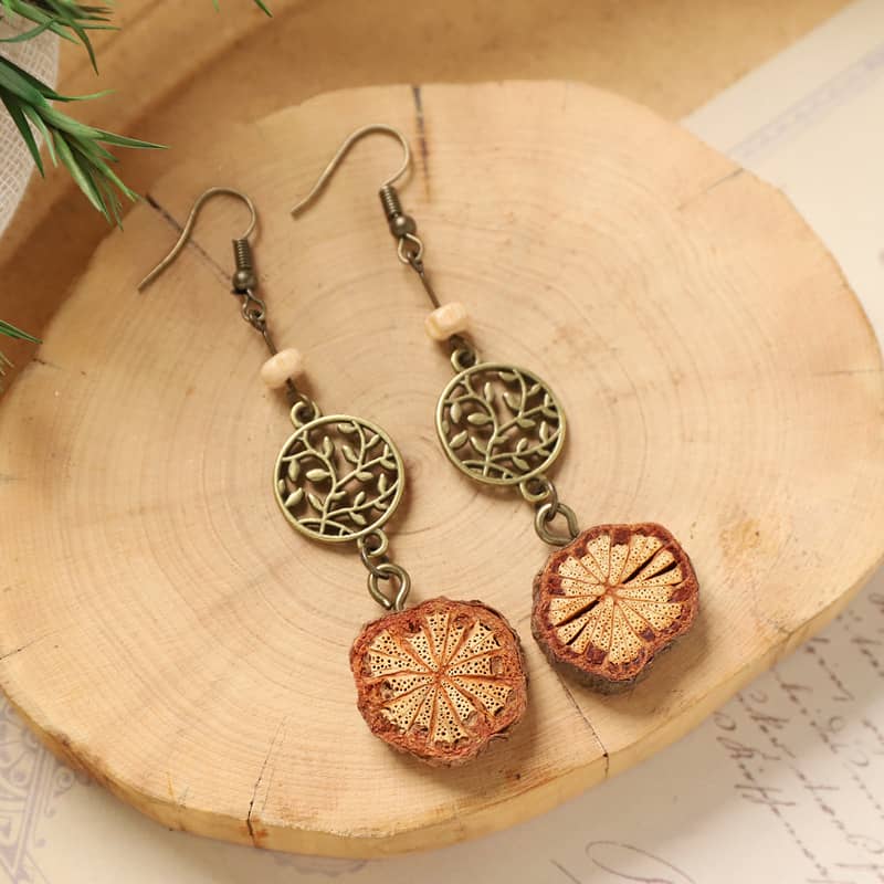 Vintage vine earrings featuring detailed wood slices and floral designs, ideal for nature lovers