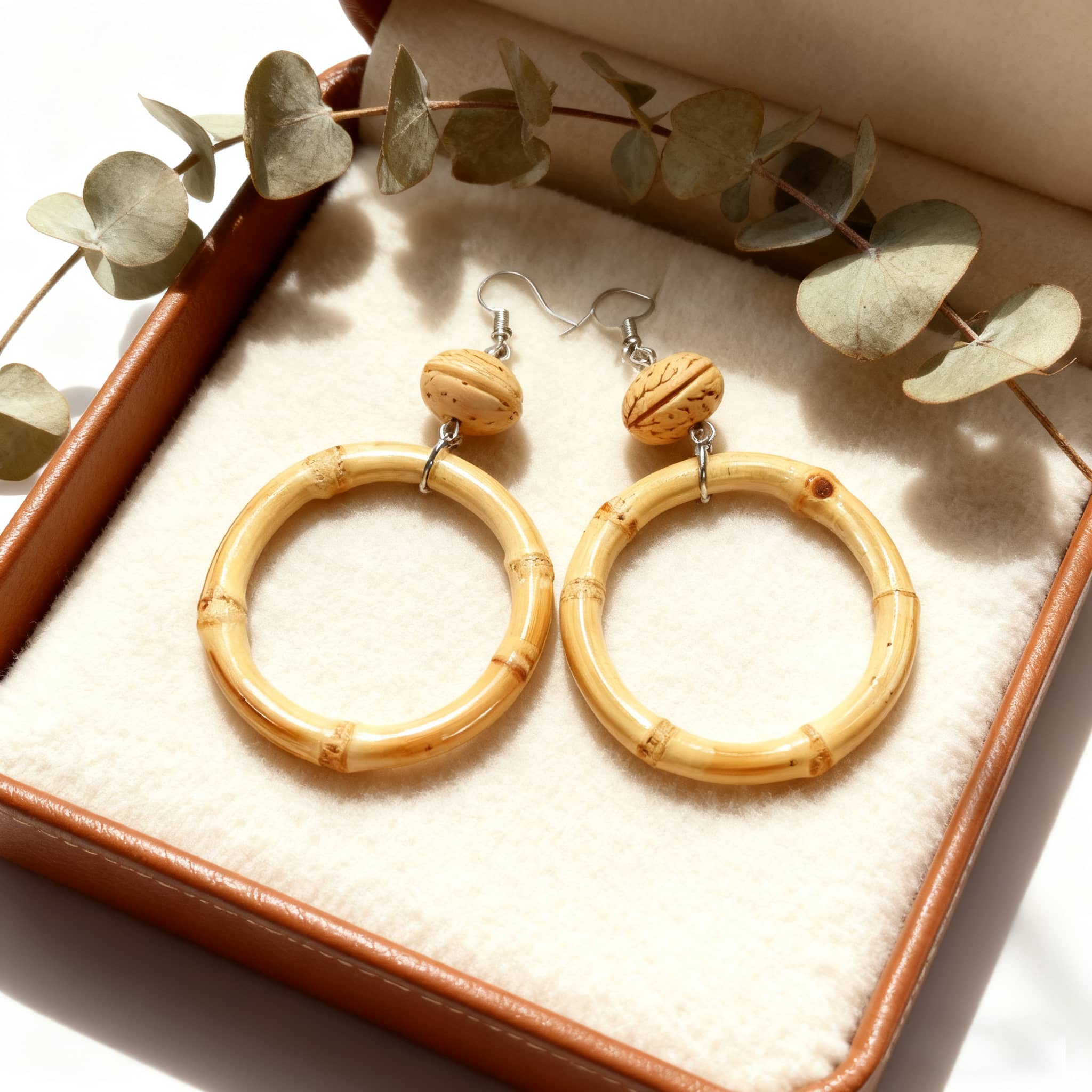 Walnut and bamboo earrings featuring a circular design with a natural finish