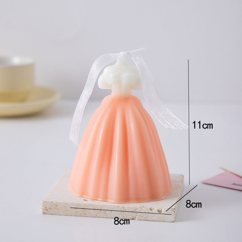 Pink and white wedding dress candle with ribbon bow decoration measuring 11cm height on marble base
